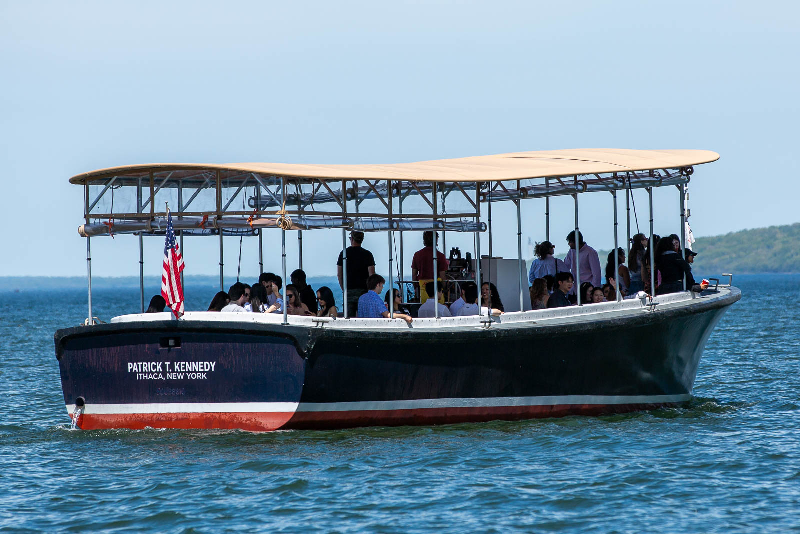 The Patrick T. Kennedy tour boat cruising on Cayuga Lake near downtown Ithaca during a narrated sightseeing and sunset cruise.